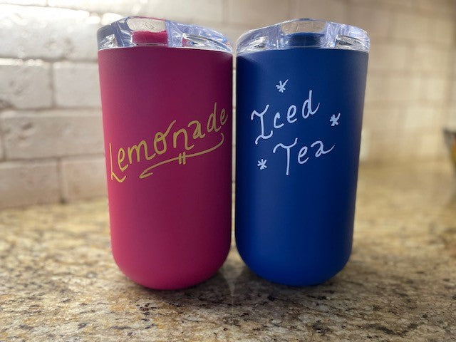 Vacuum-insulated pitchers with beverage names written on them.